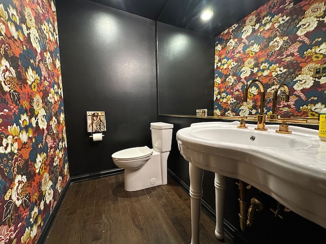 bathroom featuring toilet and wood-type flooring