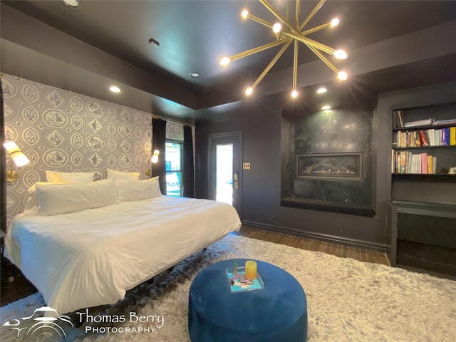 bedroom with dark wood-type flooring and a chandelier