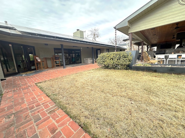 view of yard featuring ceiling fan and a patio area