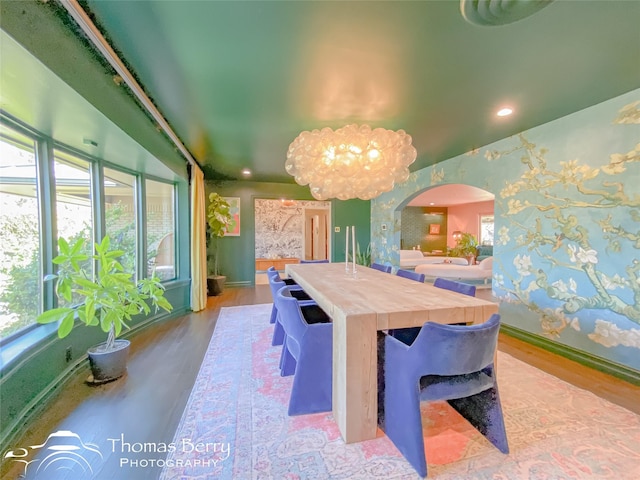 dining space featuring plenty of natural light, light hardwood / wood-style flooring, and a notable chandelier