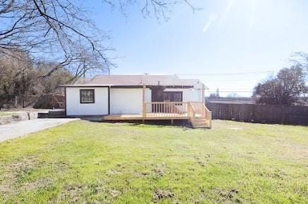 rear view of house with a lawn and a deck