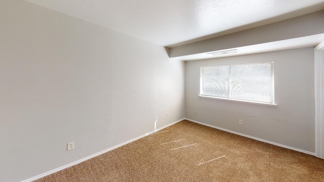 unfurnished room with carpet floors and a textured ceiling