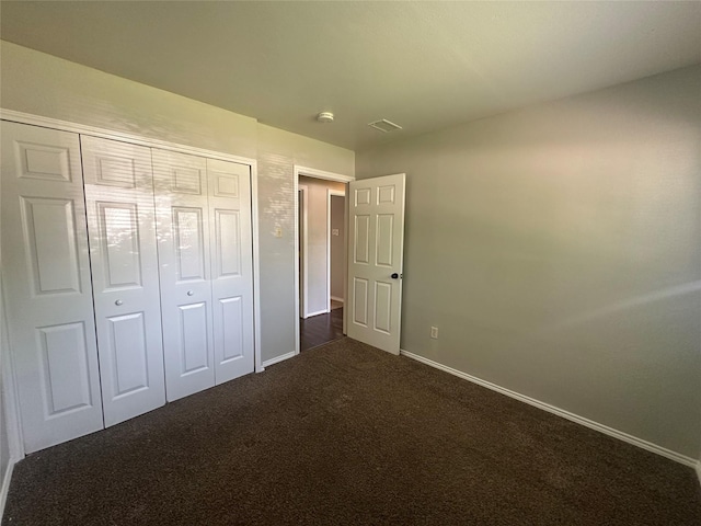 626 Sunset Dr, Garland, TX 75040 - unfurnished bedroom featuring dark colored carpet, a closet, and baseboards