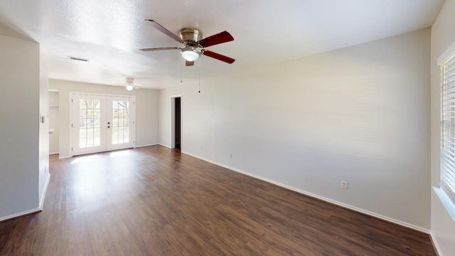 spare room featuring dark hardwood / wood-style flooring, french doors, and ceiling fan