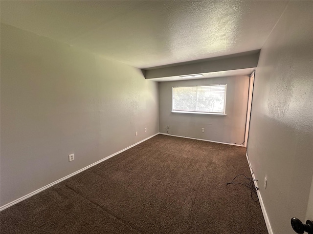 626 Sunset Dr, Garland, TX 75040 - spare room featuring visible vents, baseboards, dark carpet, and a textured ceiling