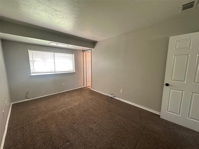 626 Sunset Dr, Garland, TX 75040 - spare room featuring visible vents, baseboards, and dark colored carpet