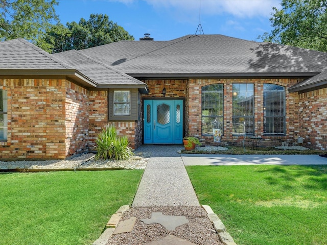 doorway to property featuring a lawn