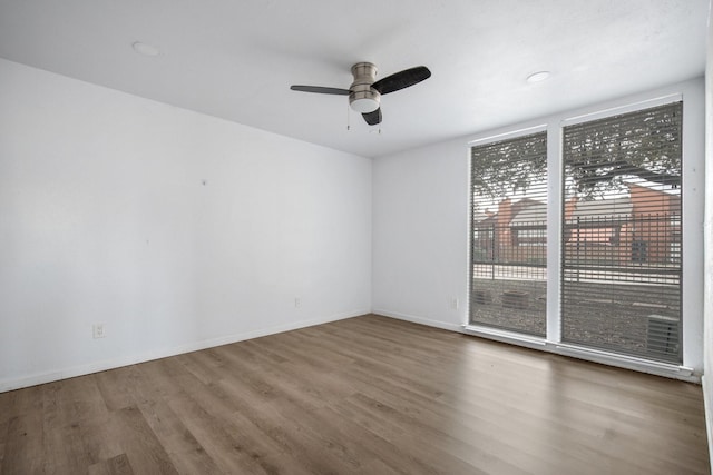 unfurnished room with ceiling fan and hardwood / wood-style floors