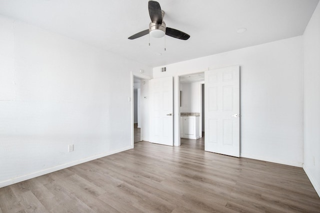 unfurnished bedroom with ceiling fan and hardwood / wood-style floors