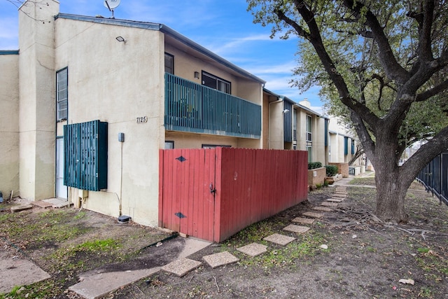 view of side of home featuring a balcony