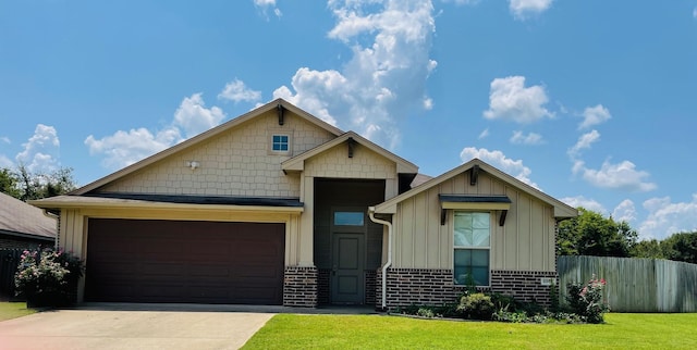 craftsman-style house featuring a front yard and a garage