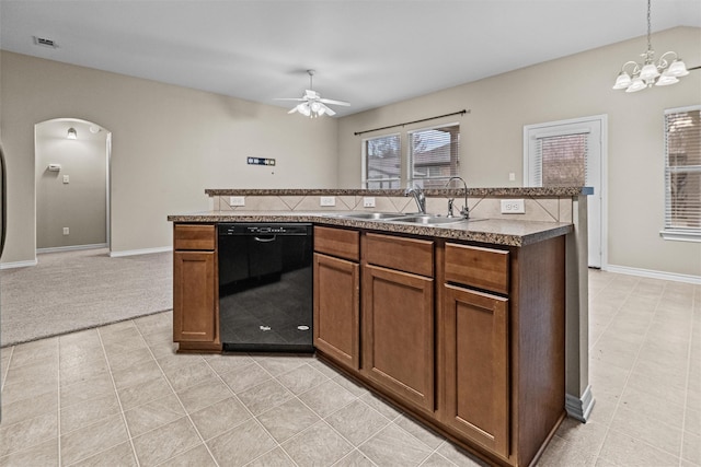 kitchen with arched walkways, a sink, visible vents, black dishwasher, and dark countertops