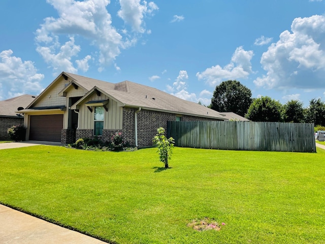 view of front of property with a garage and a front lawn