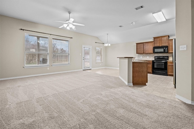 kitchen featuring brown cabinetry, open floor plan, light carpet, and black appliances