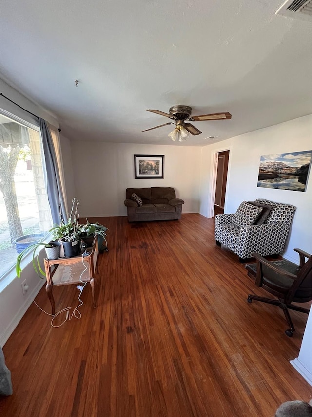 living room featuring ceiling fan, hardwood / wood-style flooring, and a wealth of natural light