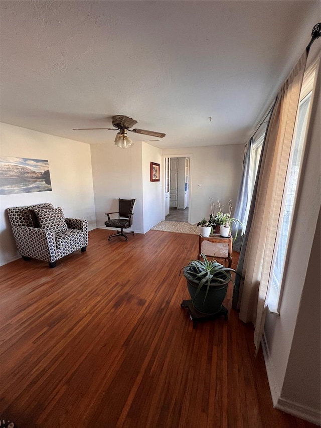 living room with hardwood / wood-style flooring and ceiling fan