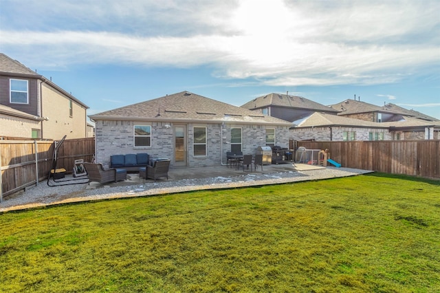 rear view of house featuring a patio area, an outdoor living space, and a lawn