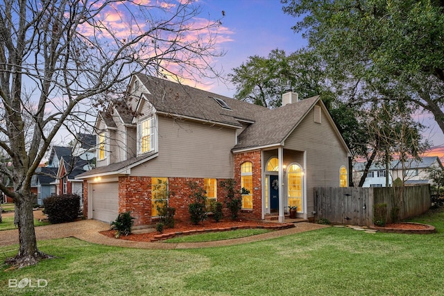 view of front facade featuring a yard and a garage