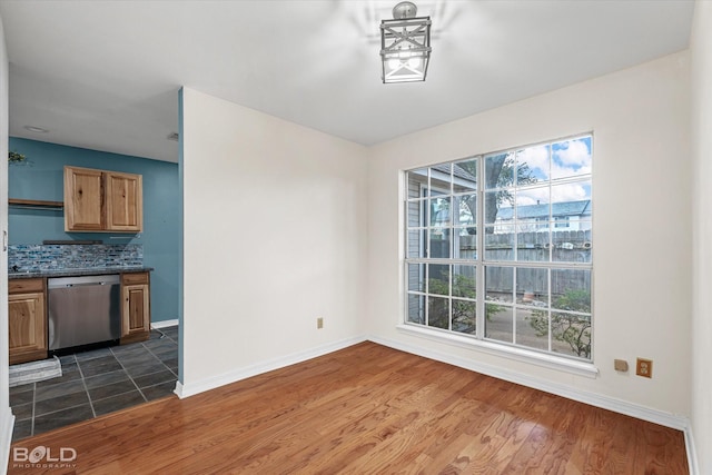 unfurnished dining area featuring dark wood-type flooring