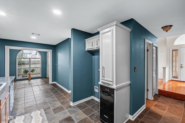 kitchen featuring white cabinets