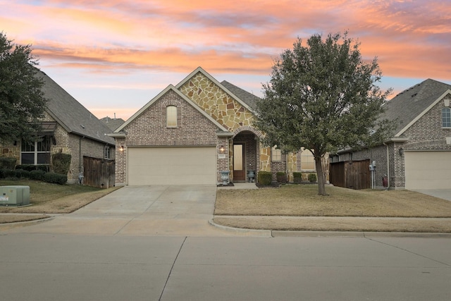 view of front of property with a yard and a garage