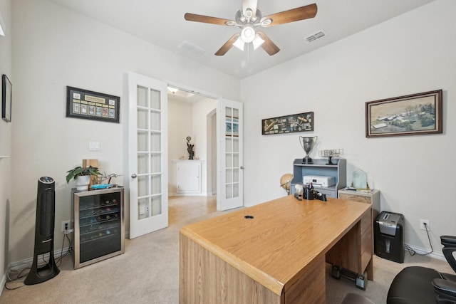 carpeted home office with ceiling fan, wine cooler, and french doors