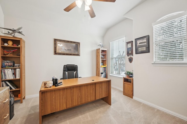 carpeted office space featuring ceiling fan