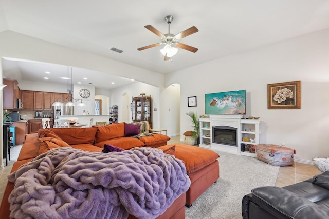 living room featuring ceiling fan and light tile patterned floors