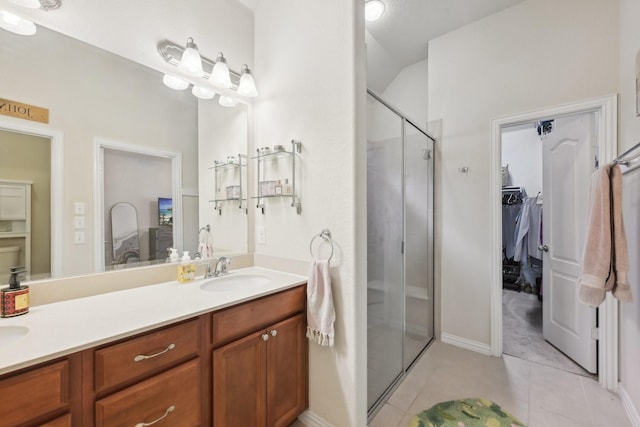 bathroom with vanity, tile patterned flooring, and a shower with door