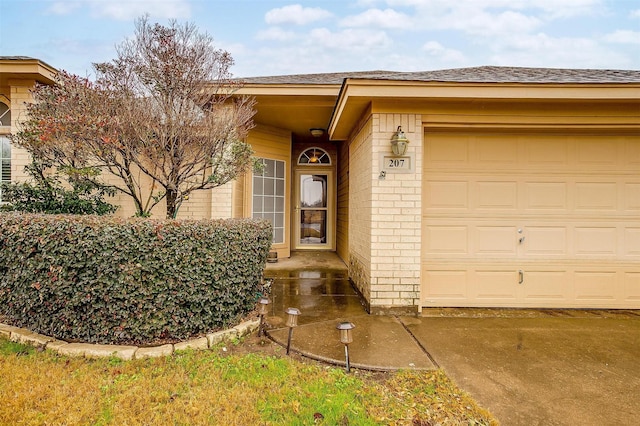 view of exterior entry with a garage