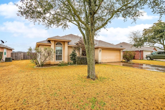 single story home with central AC, a garage, and a front lawn