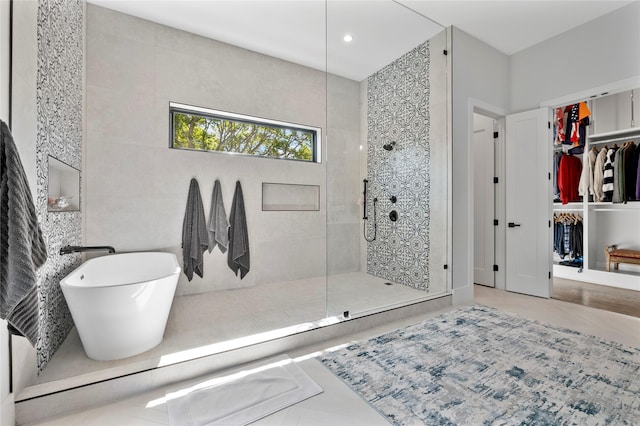 4737 Sugar Mill Rd, Dallas, TX 75244 - bathroom with a walk in closet, recessed lighting, a walk in shower, and a freestanding bath