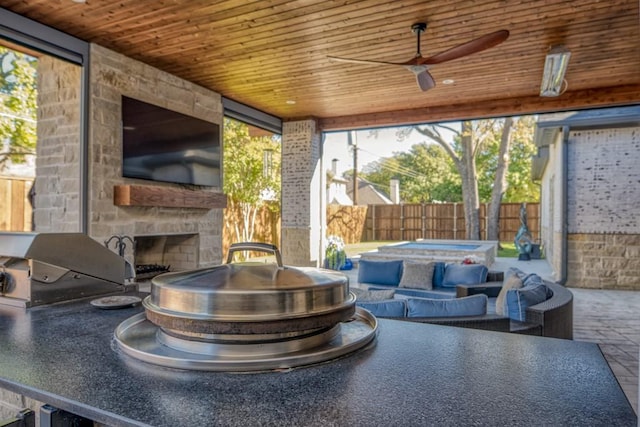 sunroom / solarium featuring an outdoor stone fireplace and wood ceiling