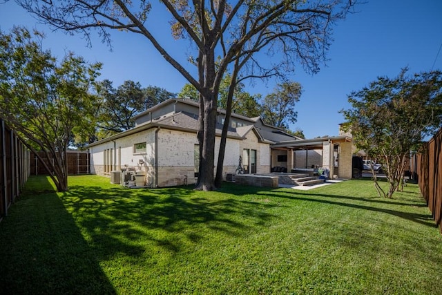 4737 Sugar Mill Rd, Dallas, TX 75244 - rear view of property featuring a patio, a fenced backyard, a lawn, central AC, and brick siding