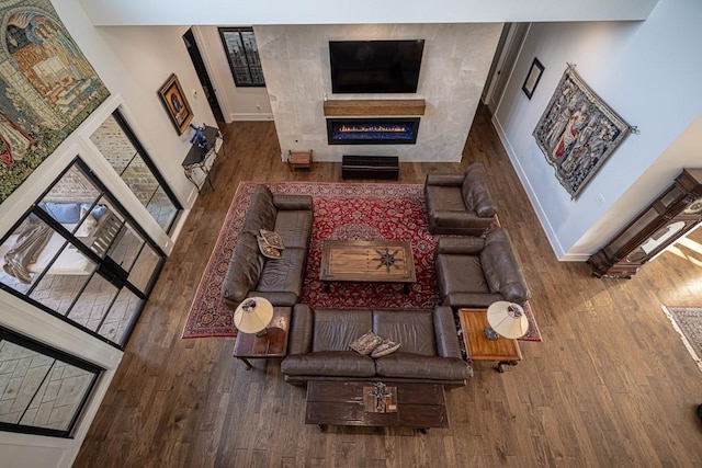 4737 Sugar Mill Rd, Dallas, TX 75244 - living room with a glass covered fireplace, wood finished floors, and baseboards