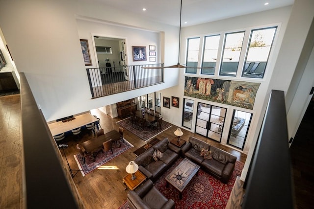 living room featuring a high ceiling and hardwood / wood-style floors