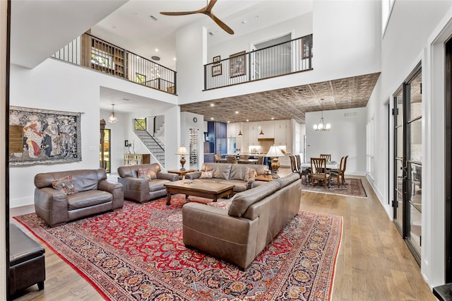4737 Sugar Mill Rd, Dallas, TX 75244 - living area with a high ceiling, stairway, baseboards, wood finished floors, and ceiling fan with notable chandelier