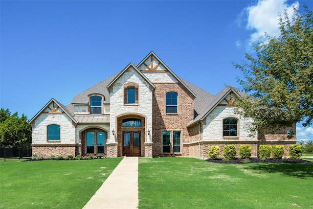 view of front of property with a front lawn and french doors