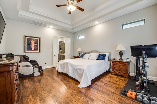 bedroom with crown molding, ceiling fan, a tray ceiling, and multiple windows