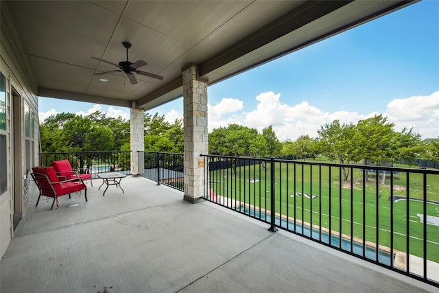 view of patio / terrace featuring a balcony and ceiling fan