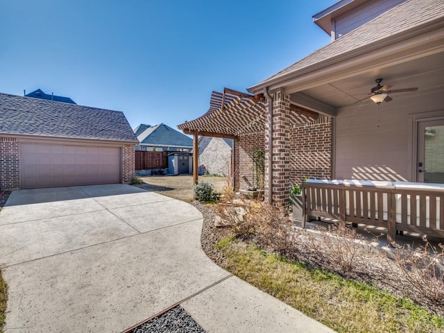 exterior space with a garage and ceiling fan