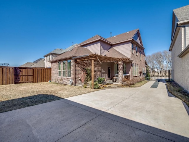 rear view of house featuring a patio and a pergola