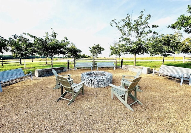 view of yard with a water view and an outdoor fire pit