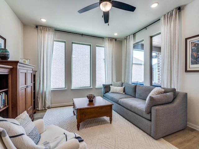 living room featuring recessed lighting, light wood-style flooring, baseboards, and a ceiling fan