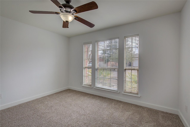 empty room featuring carpet flooring and ceiling fan