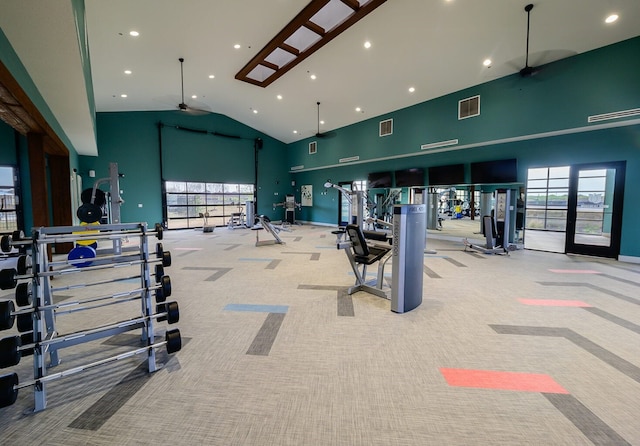 exercise room featuring ceiling fan, high vaulted ceiling, and light carpet