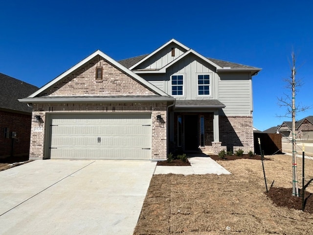 view of front of house featuring board and batten siding, concrete driveway, brick siding, and an attached garage