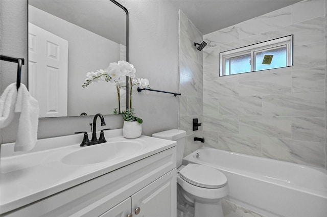 full bathroom with tiled shower / bath combo, toilet, and vanity