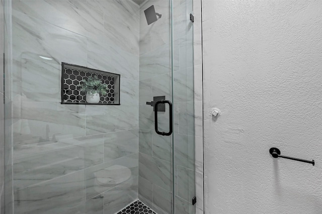 bathroom with a shower with door