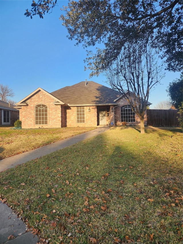 single story home featuring a front yard